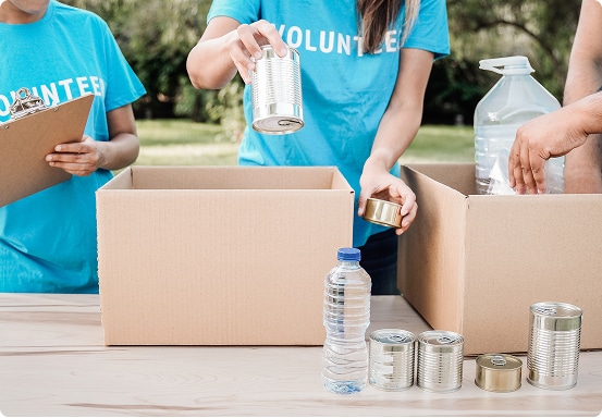 volunteers packing cans in boxes